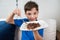 Closeup of an 8 year old child holding a plate with brigadeiro and putting the spoon