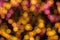 Closeup abstract blurred and bokeh of reflection lighting of pink and yellow led light bubs on black background