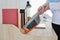 Closeup active young asian muslim housewife woman hands cleaning with vacuum cleaning wooden table