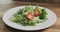 Closeup adding tomatoes to caesar salad