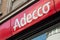 Closeup of Adecco sign on building facade, Adecco is the famous french Temporary work agency