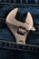 Closeup of an adjustable wrench in jean pocket