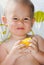 Closeup of adorable child eating sweet corn