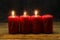 Closeup advent candles in a row behind a wet glass