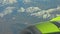 Closeup aerial view of airplane flying over mountains of Kamchatka peninsula outdoors.