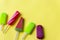 Closeup aerial view of colorful ice cream on yellow background