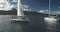 Closeup aerial of yachts cruising at seascape of ocean bay coast of mountain Arran island, Scotland