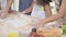 Closeup African American family with daughter rolling for thresh flour for cooking with father and mother together.