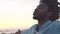 Closeup of an African American man finding inner peace at sunset, tranquil and quiet at a beach with copyspace. Black