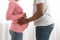 Closeup of african american pregnant couple embracing at home