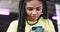 Closeup african lady with a long hair dreadlocks buy something online using her smartphone and bank card