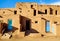 Closeup of aged buildings in Taos Pueblo under the sunlight and a blue sky in New