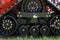 Closeup of an agricultural machinery tire with on an orange wheel