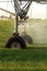 A closeup of an agricultural sprinkler system irrigating a field of Idaho wheat.