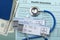 Closeup of airplane tickets, stethoscope, cash, passport, health insurance police.Concept of travel safety