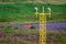 A closeup of an airport runway approach light. Yellow light pole.