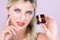 Closeup alluring portrait of perfect skin woman holding mockup moisturizer jar.