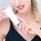 Closeup alluring portrait of perfect skin woman holding mockup moisturizer tube.