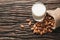 Closeup almonds and milk on wooden texture on dark background