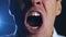 Closeup angry businessman screaming. Aggressive boss threatens violence. Stress at work.