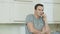 Closeup angry man talking phone at kitchen. Portrait of aggressive man