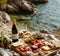 Closeup Antipasto platter with prosciutto crudo or jamon, salami, olives and white wine on a wooden board on the background of the