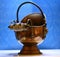 Closeup of antique copper coal scuttle ash bucket