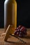 Closeup of an antique cork screw with out of focus white wine bottle grapes and cork in the background