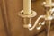 Closeup of  antique gold plated candelabrum with candle