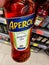 Closeup of Aperol bottle hold by hand in german supermarket