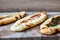 Closeup of appetizing pide flatbread variety stuffed with toppings on a wooden surface