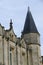 Closeup architectural details of ancient historic castle or chateau in France - against blue sky white clouds