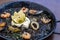 Closeup of Arros negre served on a pan in a restaurant