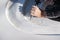 Closeup of an artist carving curves into a white stone