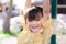 Closeup, Asian adorable girls trapeze for exercise. Cute kids wearing a yellow blouse. Child smiles sweet, good mood.