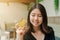 Closeup Asian beautiful woman Wearing a black shirt Sitting in the house Have a credit card in hand Happy face