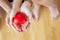 Closeup asian couple holding a red heart shape on hands, hands of man and woman feeling happiness and romantic