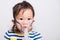 Closeup Asian face, Little baby girl sick her using steam inhaler nebulizer mask inhalation oneself