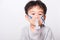 Closeup Asian face, Little children boy sick he using steam inhaler nebulizer mask inhalation oneself
