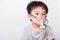 Closeup Asian face, Little children boy sick he using steam inhaler nebulizer mask inhalation oneself