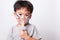 Closeup Asian face, Little children boy sick he using steam inhaler nebulizer mask inhalation oneself