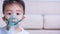 Closeup asian face little children boy using steam inhaler nebulizer mask inhalation