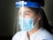 Closeup asian female doctor wears face shield and mask to protect herself from virus spreading.