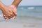 Closeup asian gay couple holding hands together on the beach with relax and leisure in summer