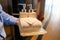 Closeup Asian hotel chambermaid man holding clean folded towels in hotel corridor