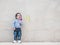 Closeup asian kid with cute medical icon on marble wall textured background in a kid want to be a doctor in a future concept with