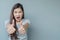 Closeup asian woman with admire motion on blurred cement wall textured background with copy space