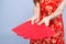 Closeup asian woman cheongsam dress holding red envelope on white background, girl celebrate with exciting
