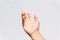Closeup of asking hand sign against a white wall background