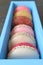 Closeup assortment of pastel colors Macaron pastries in light blue box